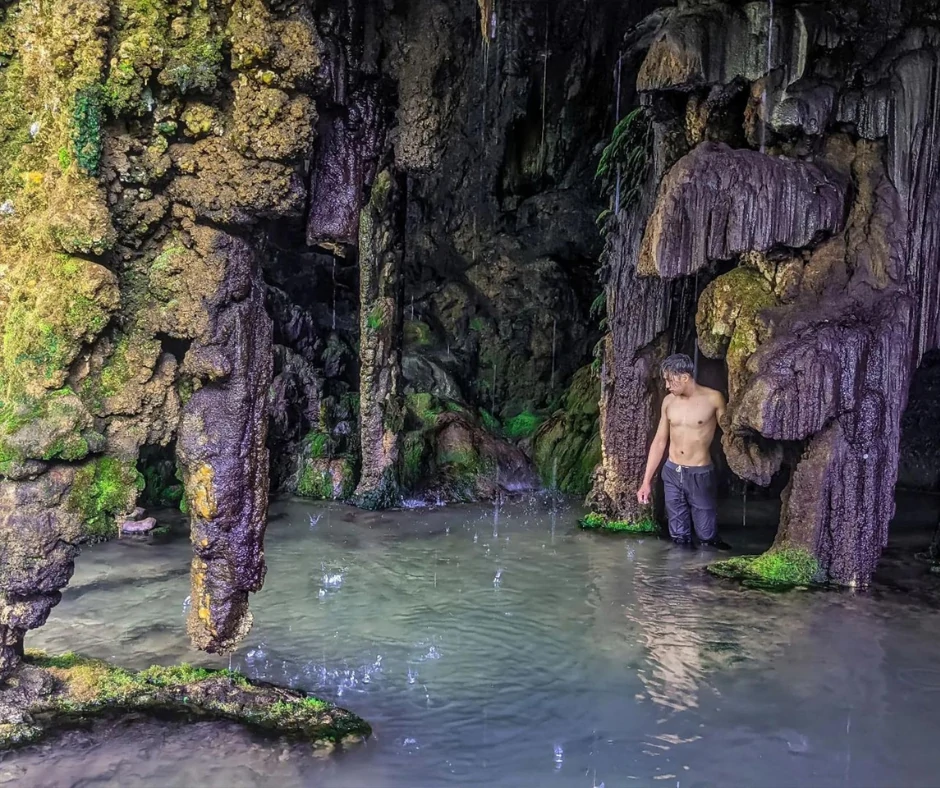 Tumpak Sewu waterfall cascading down into the pool, surrounded by lush greenery 4