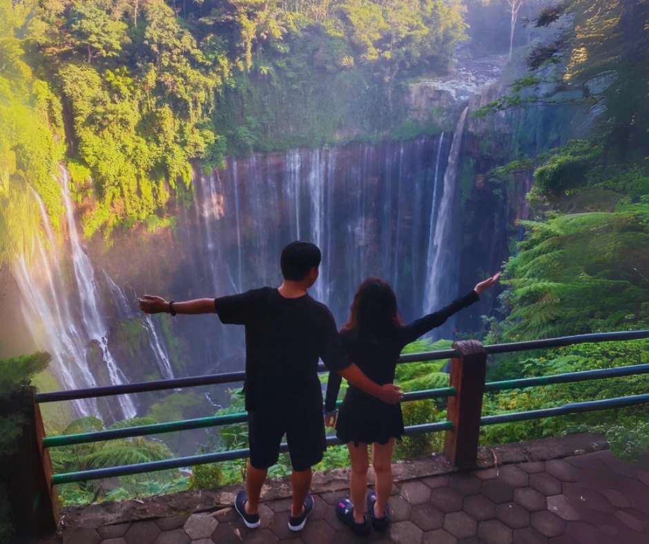 Tumpak Sewu waterfall cascading down into the pool, surrounded by lush greenery 2